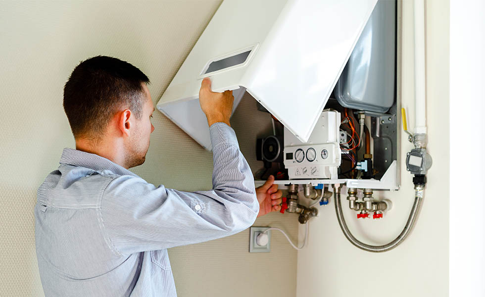 Photo of a man inspecting a boiler