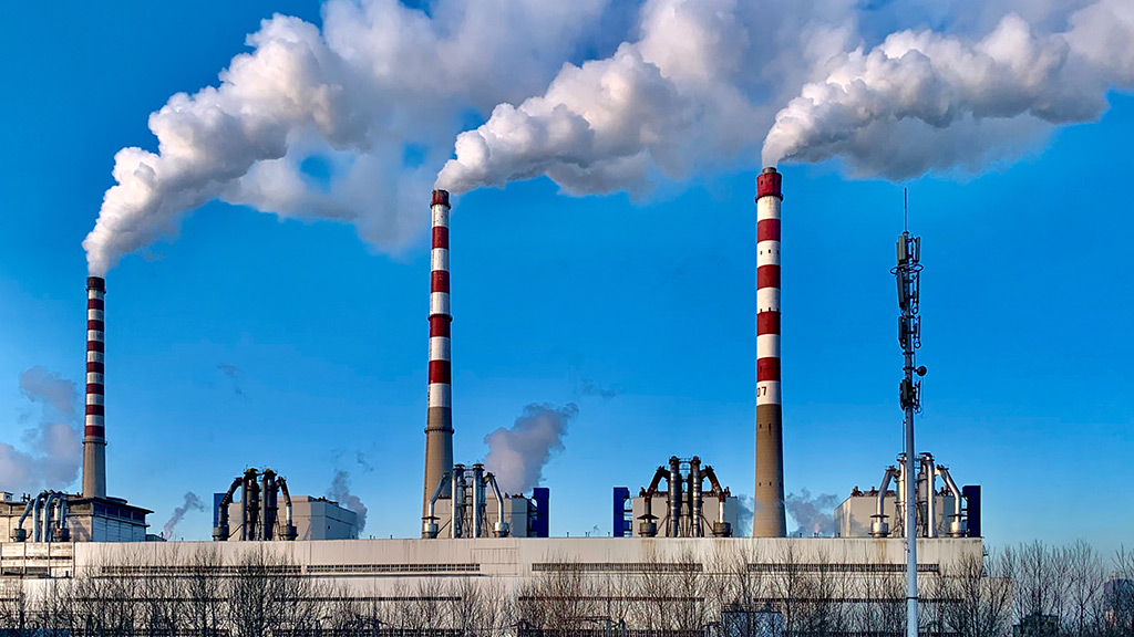 Industrial chimneys billowing smoke