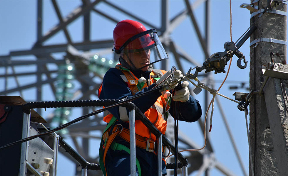 Photo of workman on electrical cables