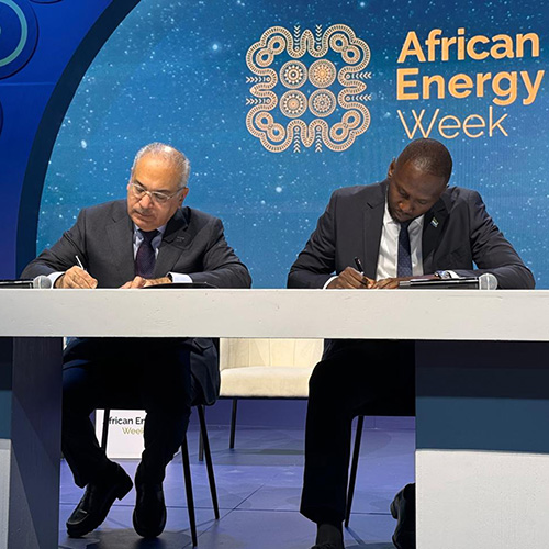 Photo of Jassim Alshirawi and Foday Mansaray signing the accession